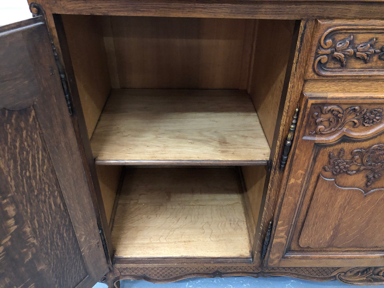 French Louis XV style Oak sideboard with beautiful carvings. Plenty Of storage space with four cupboards and two drawers. In very good original detailed condition.