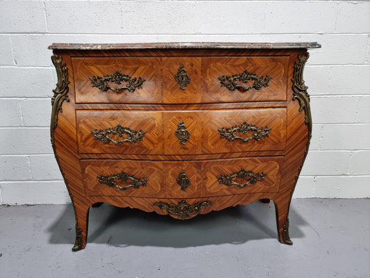 Attractive French marble top Louis XV style three drawer commode with decorative ormolu mounts. In good original detailed condition.