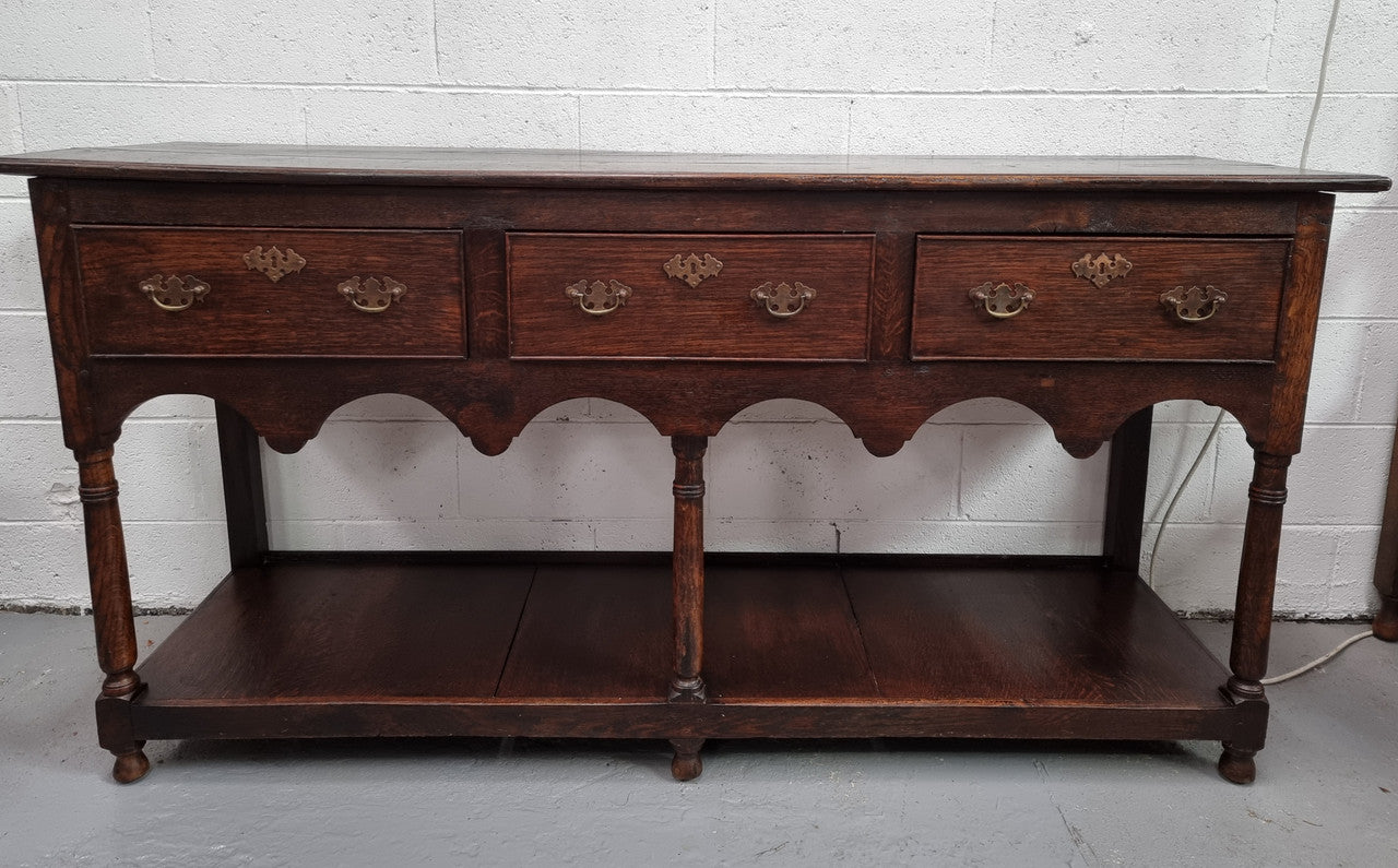 Antique 19th Century English dark Oak three drawer Dresser with brass handles and in good original condition.