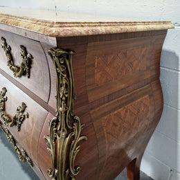 A beautifully inlaid parquetry three drawer commode with a lovely marble top, and decorative ormolu mounts. In good original detailed condition. Circa 1930