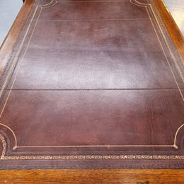 Substantial French Louis XVI style Oak partners desk. It has a beautiful leather top, two drawers on either side and decorative carvings throughout. Sourced from France and in good original detailed condition.