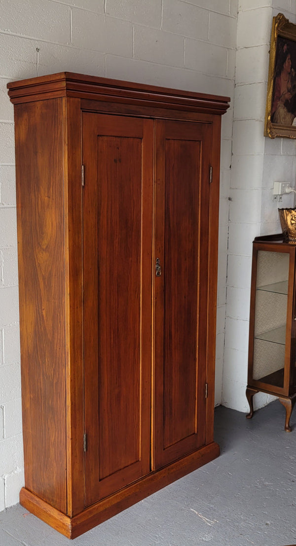 Australian Victorian Pine storage cupboard of pleasing narrow portions. Heaps of storage space and is in very good original detailed condition.