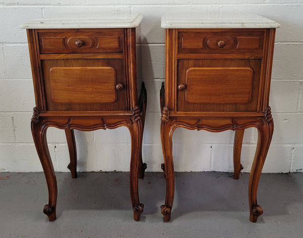 Pair of stunning Louis XV style French Walnut white marble top bedside cabinets. They have one drawer and a cupboard that is marble lined. The marble has been polished and they are in good original detailed condition.