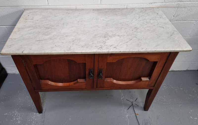 Blackwood two door white marble top cabinet. This would be ideal to be used as an entertainment unit, a TV stand or TV cabinet. In good original condition.