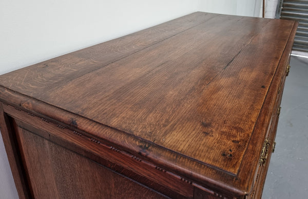 Early 19th Century French Oak chest of three drawers. It has beautiful handles and carvings. It is in good original detailed condition.