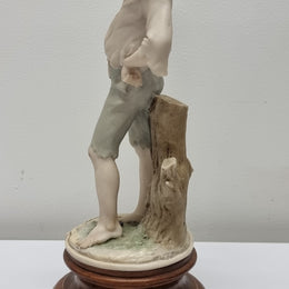 Lovely Italian figurine of boy carrying basket with grapes on a wooden base. It is signed Giuseppe Armani and 1982 FLORENCE. In good original condition.  Please view photos as they form part of the description.