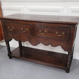 Rare size 19th Century English oak dresser base. It has two good size drawers and amazing patina. It has been sourced from France and in good original detailed condition.