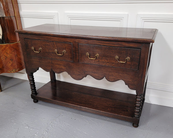 Rare size 19th Century English oak dresser base. It has two good size drawers and amazing patina. It has been sourced from France and in good original detailed condition.