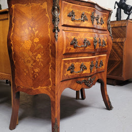 Antique French Louis XV style compact three drawer marble top commode with marquetry inlay and ormolu mounts. Sourced from France and in good original detailed condition.