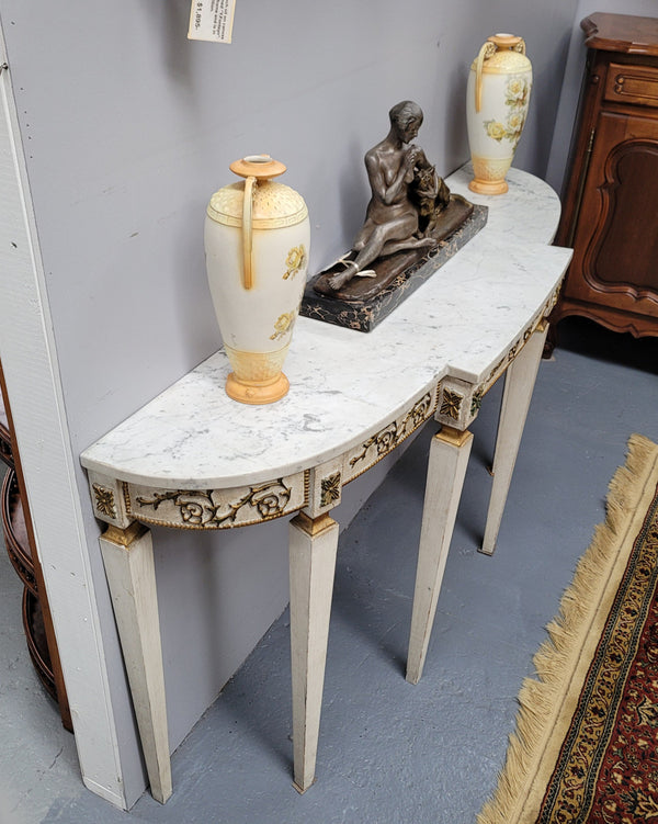 French Louis XVI style painted marble top console table. It is of pleasing narrow proportions and has been sourced from France. It is in good original detailed condition.