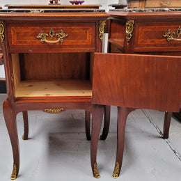 Appealing Louis XV style high quality bedside cabinets with black Portoro marble top and bronze mounts. They have been sourced from France and are in good original condition.
