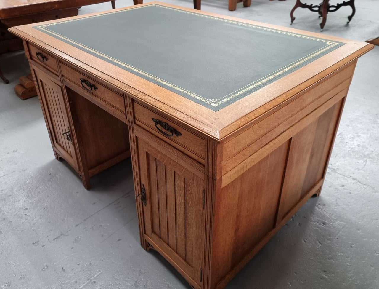 French Oak Art Deco full partners desk with leather top. Plenty of storage with both sides having three drawers at the top and two cupboards on both sides, one side has a filing section with three internal drawers and the other has a shelf on one side with three internal drawers as well. In good original detailed condition.