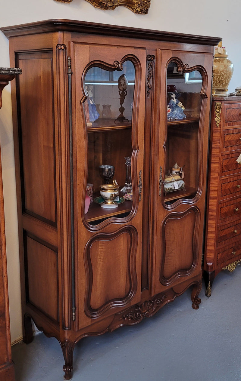 French Walnut Louis XV Style two half glass, door bookcase with three adjustable shelves. Sourced from France and in good original detailed condition.