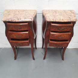 Pair of French Louis XV style miniature commode bedsides. Beautiful marquetry inlay and marble tops. In very good original condition.