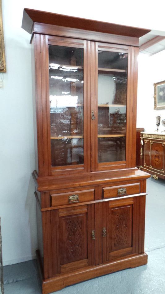 A beautiful Edwardian walnut stained bookcase with lovely carved doors and adjustable shelves. It is 227 cm tall and in very good fully restored condition.