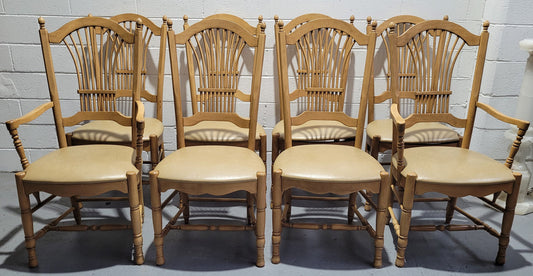 French country style set of six dining chairs and two carvers with leather seats. They are all in good original detailed condition.