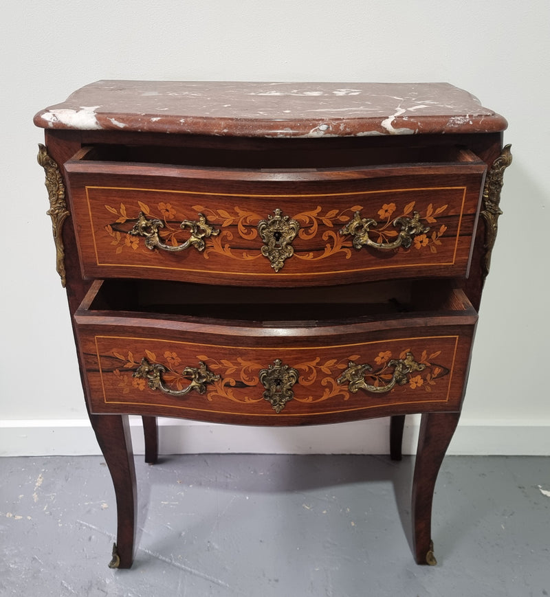 A stunning French petite two drawer inlaid Rosewood commode. In good original detailed condition.