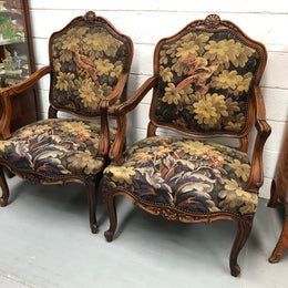Pair of 19th Century French walnut tapestry covered arm chairs. They are in good original condition. Circa 1890.