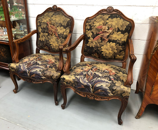 Pair of 19th Century French walnut tapestry covered arm chairs. They are in good original condition. Circa 1890.