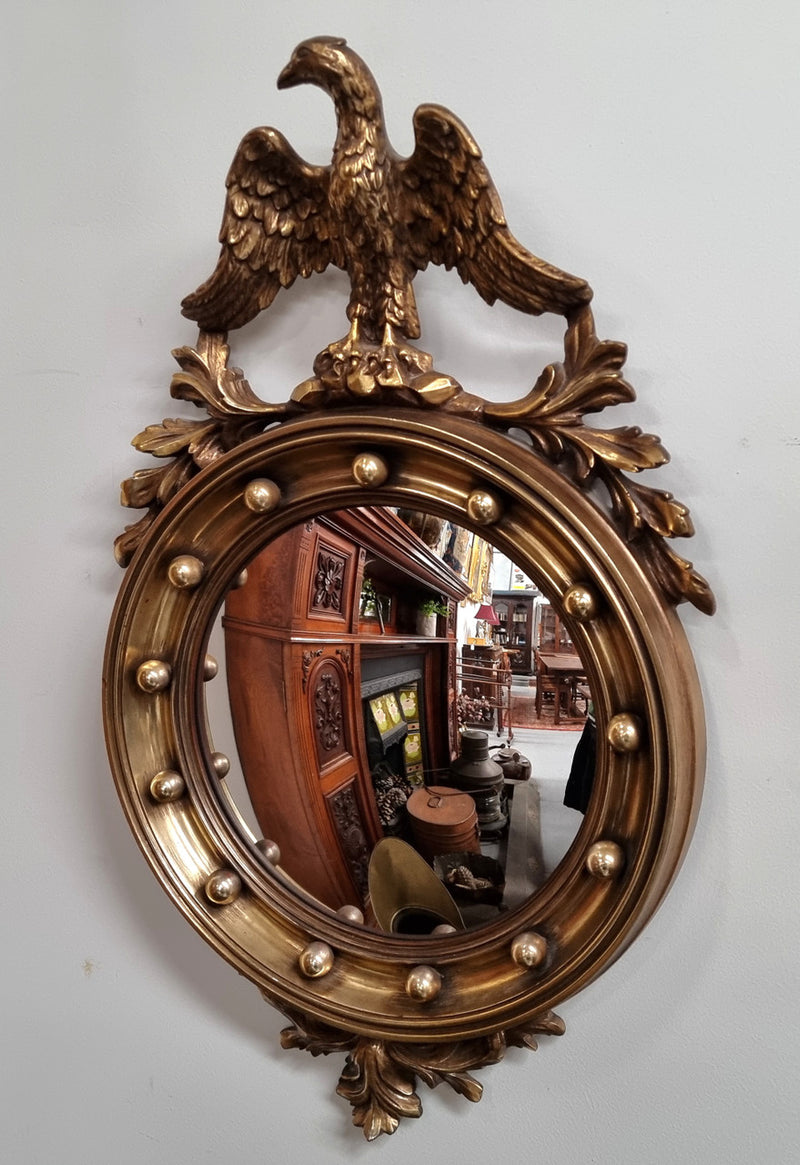 Vintage gilt framed convex mirror featuring carved eagle. It has been sourced from France and is in good original condition, please view photos as they help form part of the description.