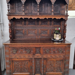Impressively carved 18th Century English Oak kitchen dresser in 17th Century Jacobean style. It is in good original detailed condition and has been sourced from France.