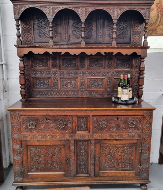 Impressively carved 18th Century English Oak kitchen dresser in 17th Century Jacobean style. It is in good original detailed condition and has been sourced from France.