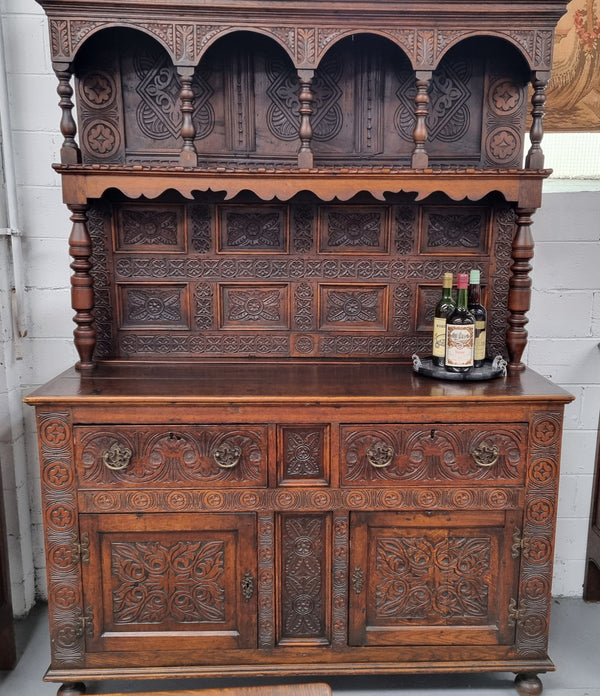 Impressively carved 18th Century English Oak kitchen dresser in 17th Century Jacobean style. It is in good original detailed condition and has been sourced from France.