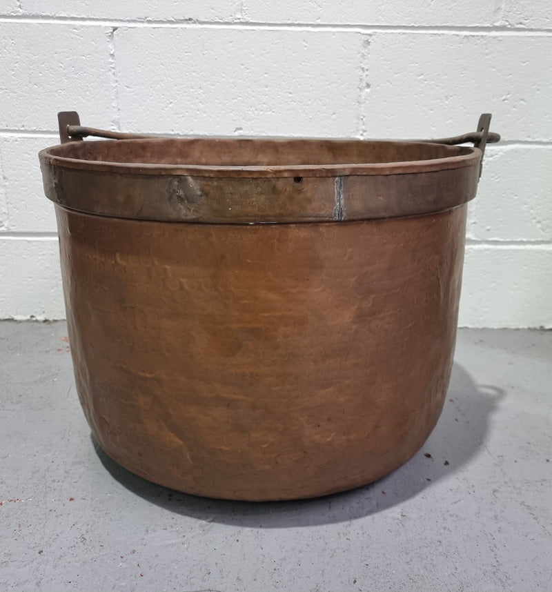 Large Antique French copper cauldron with metal band around rim. It is in good original condition.
