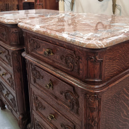 A pair of hard to find French Oak Louis XV style four drawer marble topped bedsides with attractive carvings. They are in good original detailed condition and have been sourced from France.