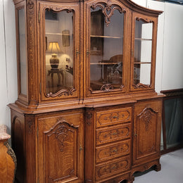 Impressive French Oak Louis 14th Style Display and Sideboard. It has 4 drawers, 2 bottom cupboards with 6 total shelves and 3 display doors with 3 shelves.  In good, detailed condition.