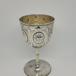 Unique Sterling Silver Christening Goblet With Repousse Motifs. Sheffield 1891. In very good original condition. Initials CJOB on one panel.