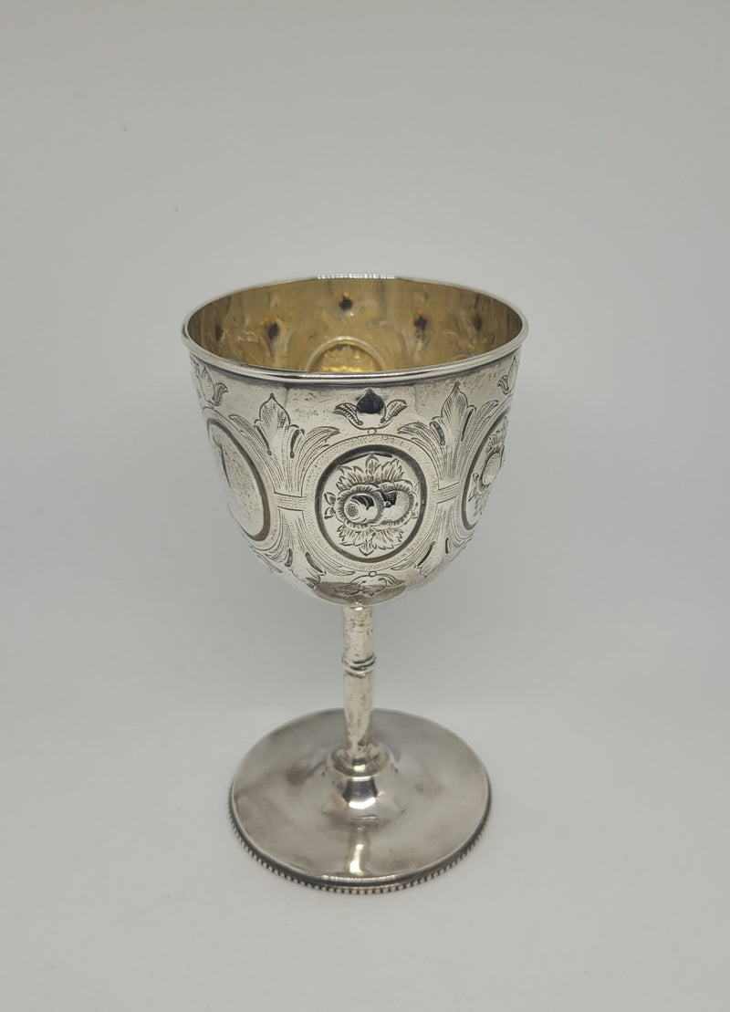 Unique Sterling Silver Christening Goblet With Repousse Motifs. Sheffield 1891. In very good original condition. Initials CJOB on one panel.