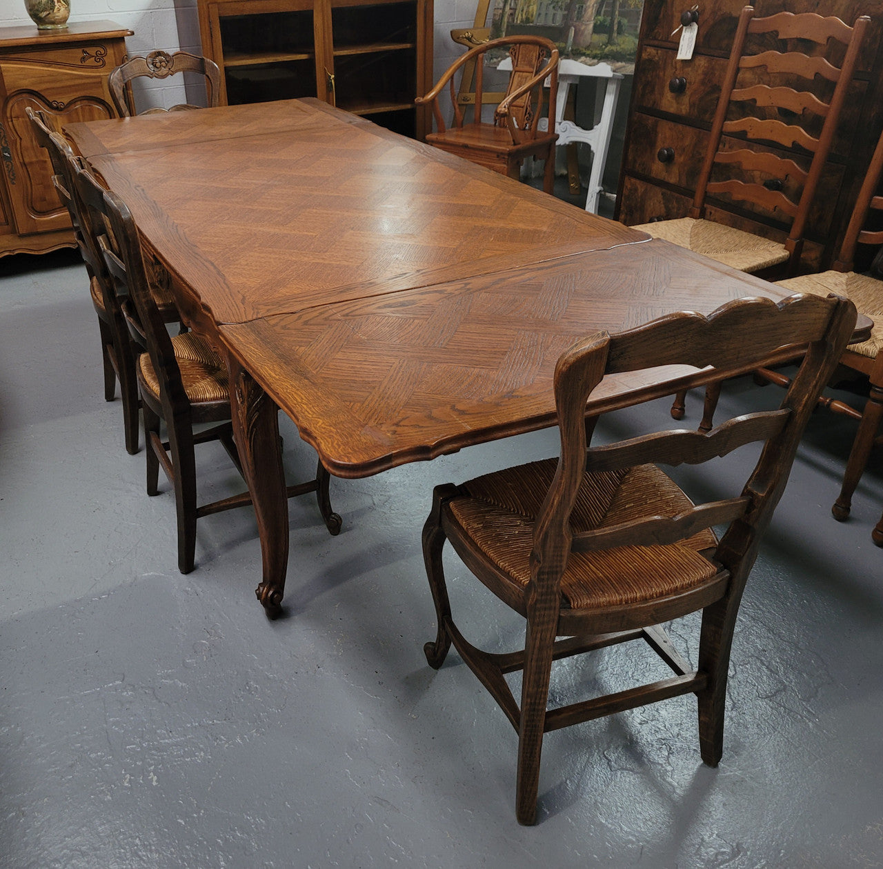 French Oak Louis XV style parquetry top extension table. It can sit six people when not extended and eight when fully extended. It has been sourced from France and is in original detailed condition.