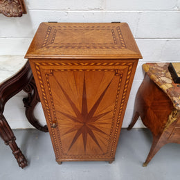 French Art Deco inlaid Oak curio/side cabinet with a lift up top and glass underneath. There are two fixed shelves, two adjustable shelves and one hidden drawer. Sourced from France and in good original condition.