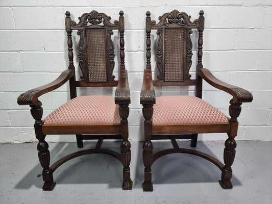 Pair oak Jacobean Revival carver chairs with cane back. In good restored condition with clean upholstery.