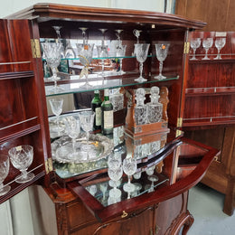 1950’s Chippendale Style Flame Mahogany Four door Bar. The top section has glass shelves and a mirrored pull out tray for storing glasses, decanters & serving etc. It also has a silver presentation plaque to the Mayor of Hawthorn 1958. The bottom section is for storage bottles etc. A stunning and practical piece.