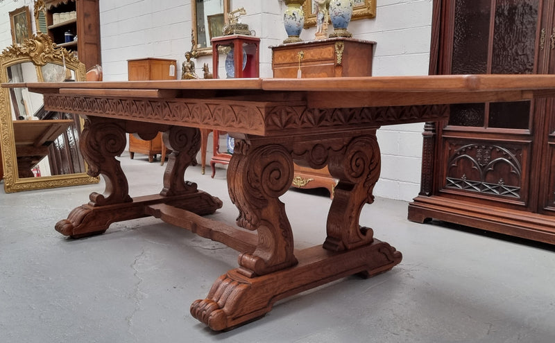 Amazing French Oak Renaissance style parquetry top extension table. Beautiful parquetry top and amazing detailed carvings on the legs. It extends to 306 cm long when fully extended. Sourced from France and in good original detailed condition.
