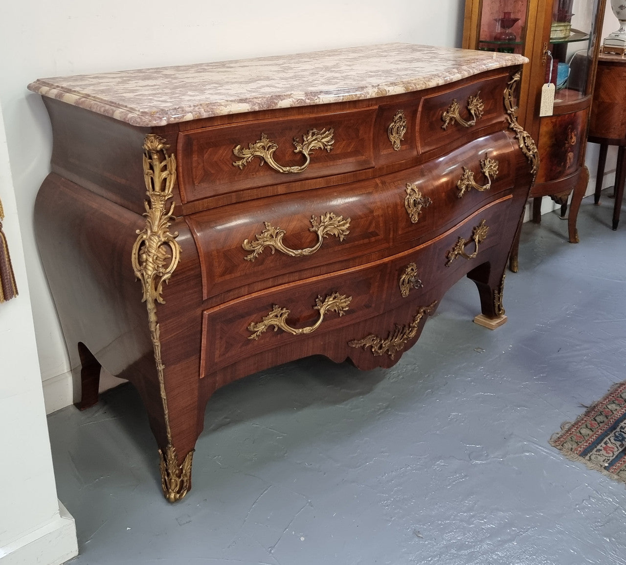 Grand French bombe shape Rosewood & Walnut marble top commode with beautiful ormolu mounts. It has two smaller drawers at the top and two larger drawers at the bottom. In good original detailed condition.