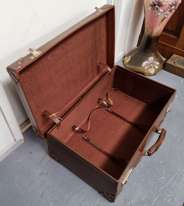 Impressive solid leather suitcase, moire fabric lined with leather straps to hold contents. Displays gold initials F.S.A near handle. With key. Please view photos as they help form part of the description.