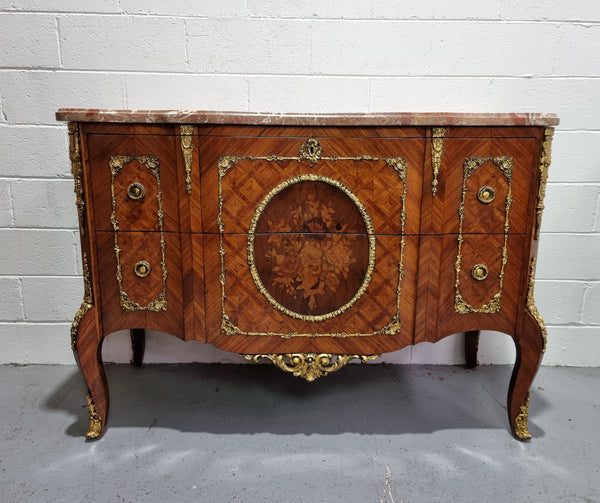 Stunning transitional French Marquetry inlaid marble top commode. It has lovely ormolu decorative mounts and an amazing thick marble top. Sourced from France and is in good original detailed condition.