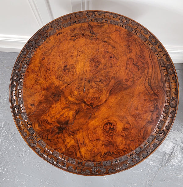 Rare early Victorian Irish Burr Walnut wine table. It has a beautiful carvings and a stunning burr walnut top, on a barley twist column and three shaped legs. It has been sourced locally and is in good original detailed condition. We also have a second table being sold separately which when together make a matched pair.