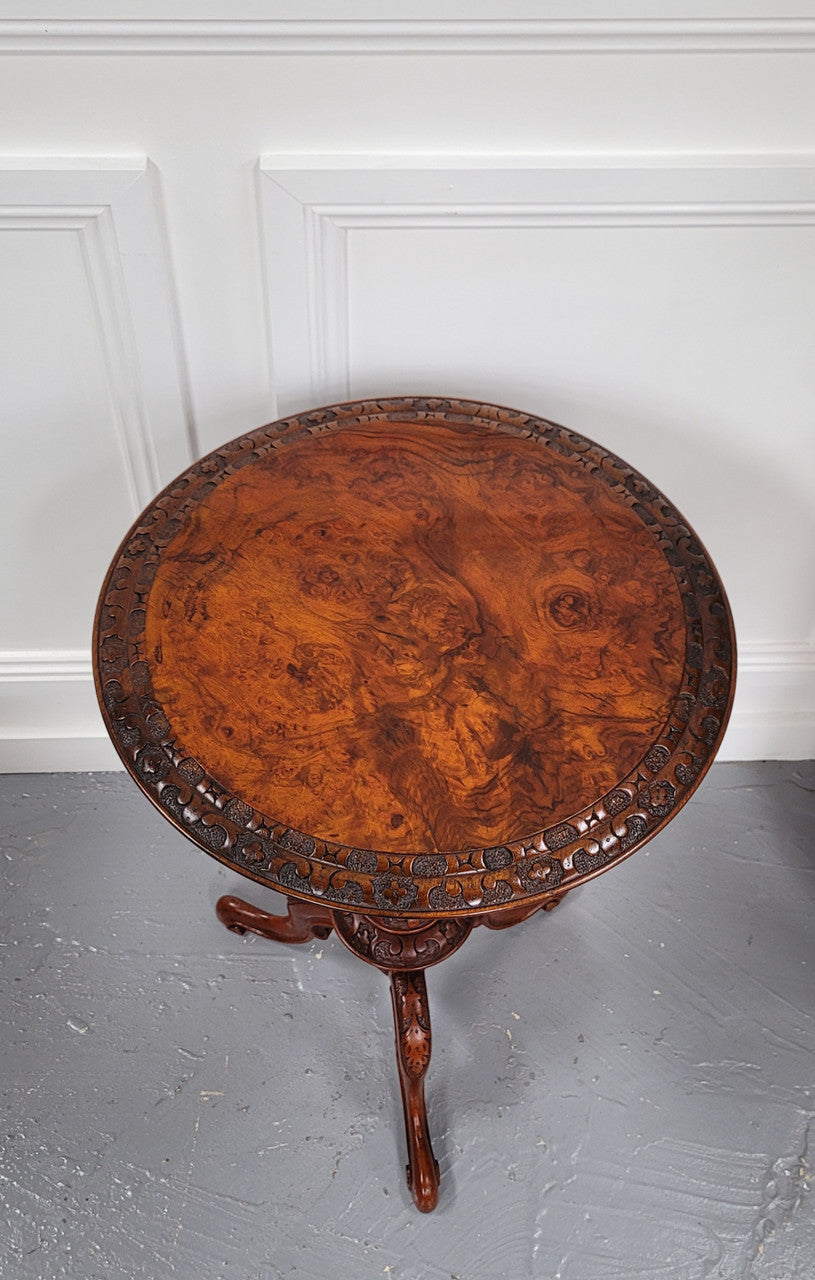 Rare early Victorian Irish Burr Walnut wine table. It has a beautiful carvings and a stunning burr walnut top, on a barley twist column and three shaped legs. It has been sourced locally and is in good original detailed condition. We also have a second table being sold separately which when together make a matched pair.