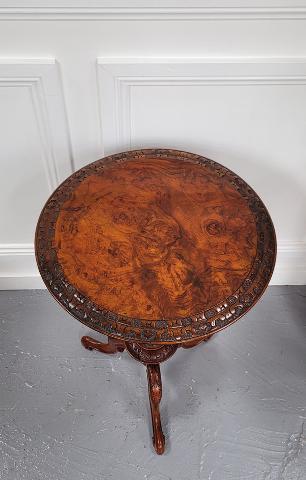 Rare early Victorian Irish Burr Walnut wine table. It has a beautiful carvings and a stunning burr walnut top, on a barley twist column and three shaped legs. It has been sourced locally and is in good original detailed condition. We also have a second table being sold separately which when together make a matched pair.