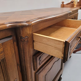 French Oak Louis XV style three door, two drawer, parquetry top sideboard. It has been sourced from France and is in good restored condition.