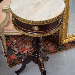 Elegant French louis XVI revival style round marble top side table with ceramic features and ormolu decoration. It is in good original detailed condition and has been sourced from France.
