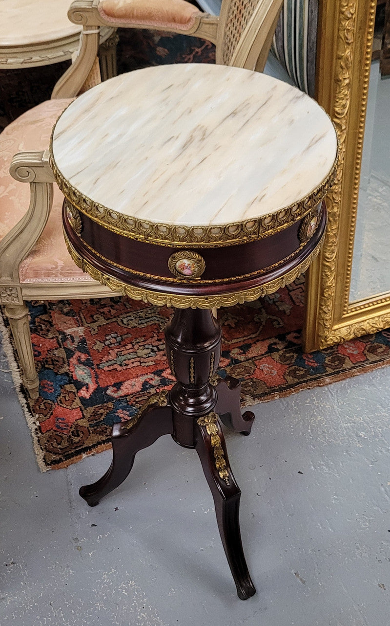 Elegant French louis XVI revival style round marble top side table with ceramic features and ormolu decoration. It is in good original detailed condition and has been sourced from France.