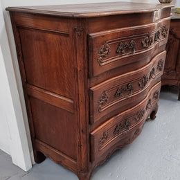 Antique French beautifully carved dark Oak commode with three drawers and ornate handles. It is in good original detailed condition.
