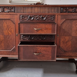 Art Deco Tudor style Oak sideboard with decorative carved detail. Plenty of storage space with two cupboards and four drawers. It has been sourced locally and is in good original detailed condition.