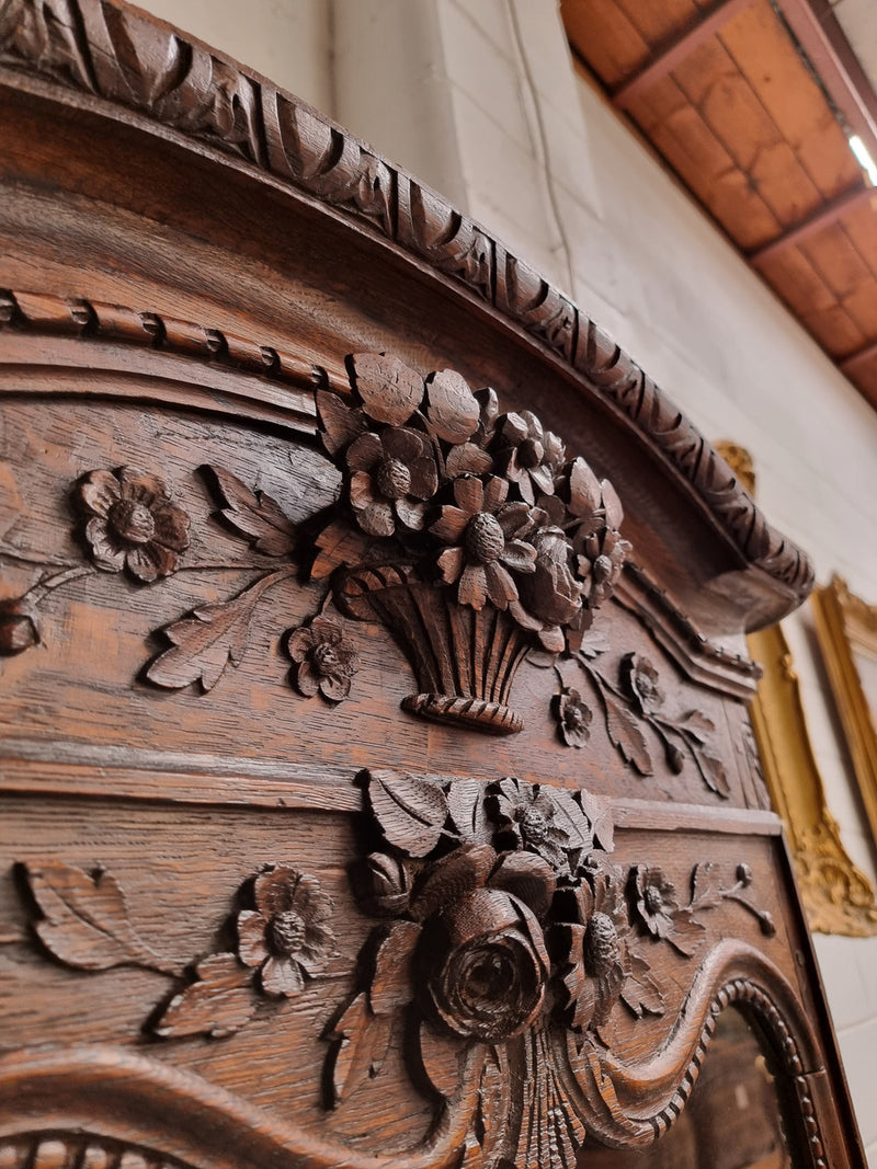 Petite oak armoire display cabinet with a glass door, two drawers at the bottom and three shelves inside. Late 18th Century and amazing detailed decorative carvings. Sourced from France and in good original condition.