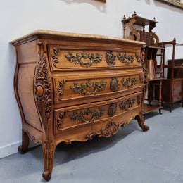 Impressive Louis XV style three drawer walnut commode. Ormolu handles and bevelled marble top complimenting detailed carving. In very good original detailed condition.